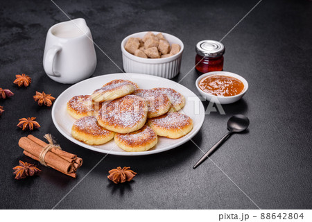 Cottage cheese pancakes with oats, syrniki on a black rustic background 88642804
