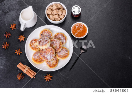Cottage cheese pancakes with oats, syrniki on a black rustic background Cottage cheese pancakes with oats, syrniki on a black rustic background 88642805