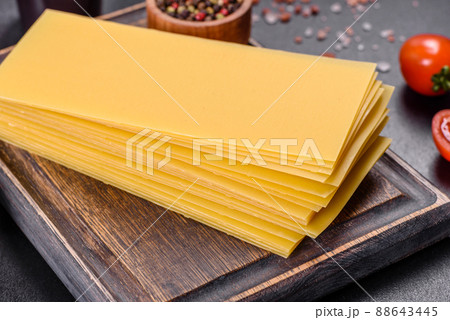 Stack of lasagna sheets on a dark concrete background. Ingredients for lasagna 88643445