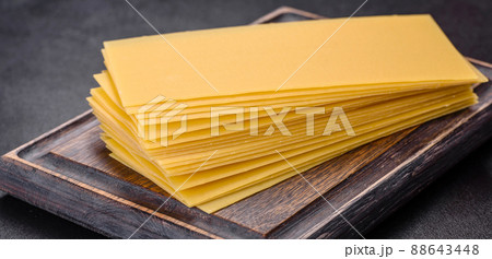 Stack of lasagna sheets on a dark concrete background. Ingredients for lasagna Stack of lasagna sheets on a dark concrete background. Ingredients for lasagna 88643448