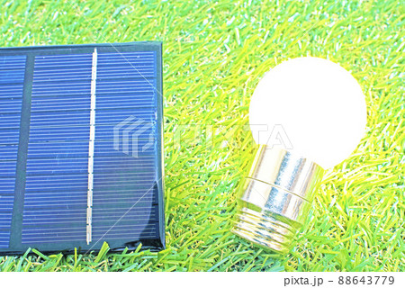 芝生と太陽光パネルと光っている状態の電球 88643779
