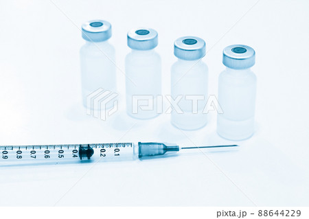 Vial of Drugs and 1 ml Plastic Syringe with Needle Isolated on the White Background Vial of Drugs and 1 ml Plastic Syringe with Needle Isolated on the White Background 88644229