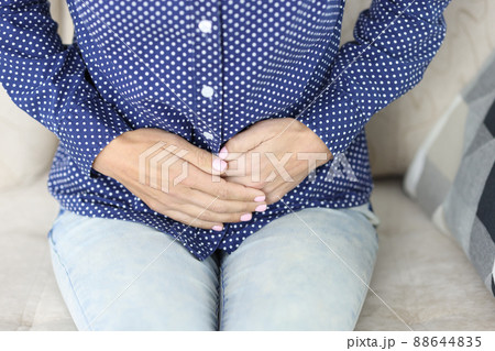 Women hands on stomach with painful spasms closeup Women hands on stomach with painful spasms closeup 88644835