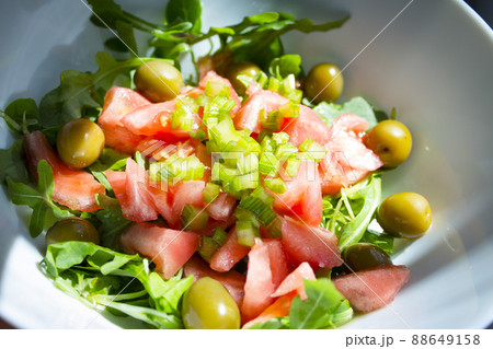 Arugula salad with tomato olives and pickles Arugula salad with tomato olives and pickles 88649158