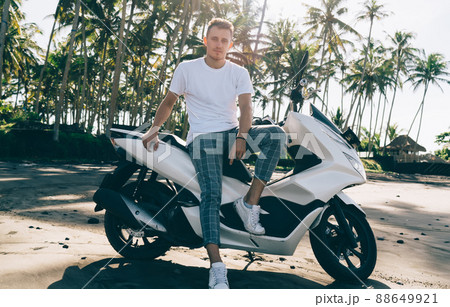 Trendy man sitting on modern scooter 88649921