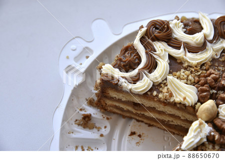 Black cake with nuts on a backing 88650670