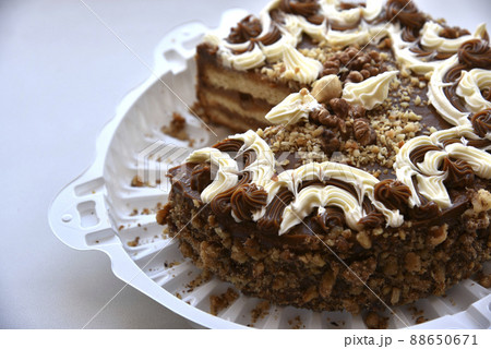 Black cake with nuts on a backing 88650671