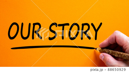 Hand writing 'our story', isolated on beautiful orange background. Business concept, copy space. Hand writing 'our story', isolated on beautiful orange background. Business concept, copy space. 88650929