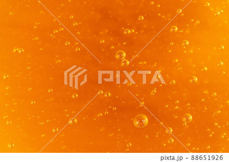 Macro honey bubbles close-up bright amber color. The texture of honey. The concept of healthy eating. Diet. Macro honey bubbles close-up bright amber color. The texture of honey. The concept of healthy eating. Diet. 88651926
