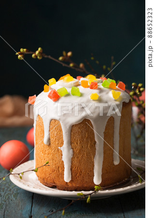 Easter cakes decorated with candied fruit on a wooden background Easter cakes decorated with candied fruit on a wooden background 88652323