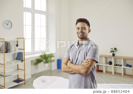Portrait of happy male doctor, physiotherapist or massagist at rehabilitation centre 88652404