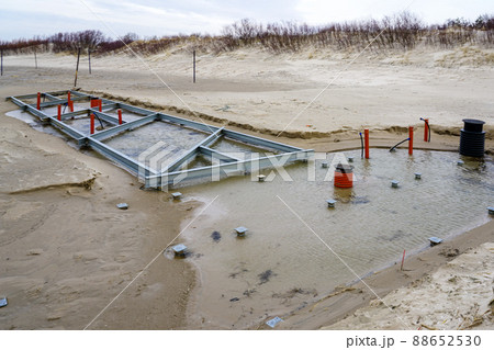 construction of metal beam foundations with communications for seasonal building on the beach construction of metal beam foundations with communications for seasonal building on the beach 88652530
