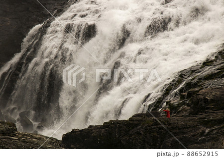Woman in red dress in Kjosfossen Woman in red dress in Kjosfossen 88652915