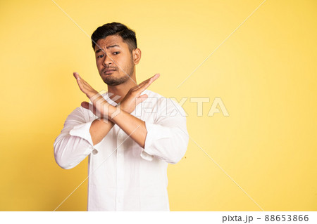 asian young man rejects offer with crossed arms 88653866