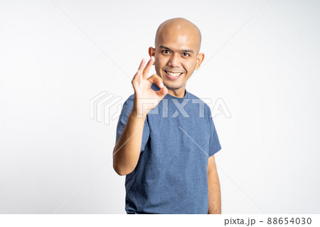 asian bald man smiling with okay gesture while - Stock Photo