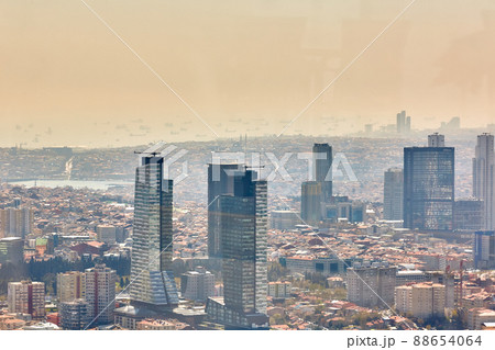 Istanbul, Turkey - 1 April, 2017: Urban landscape of European side of Istanbul and Bosphorus Strait on a horizon. Modern part of city with business towers of international corporations, skyscrapers Istanbul, Turkey - 1 April, 2017: Urban landscape of European side of Istanbul and Bosphorus Strait on a horizon. Modern part of city with business towers of international corporations, skyscrapers 88654064