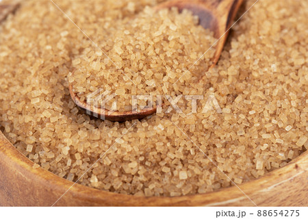 Close-up of cane sugar in a wooden spoon. Close-up of cane sugar in a wooden spoon. 88654275