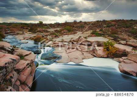 Beautiful mountain river flowing over rocks. Flow of water in mountain river close up 88654870