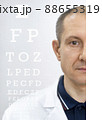 Demonstration of vision diagnostics, using a font table, with the cover of one of the eyes. 88655319