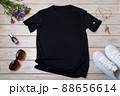 Womens black T-shirt mockup with burdock flowers 88656614