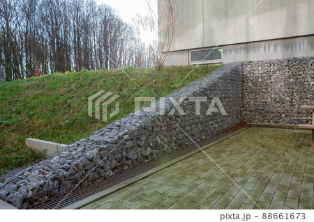 Fence of stones in an iron cage 88661673