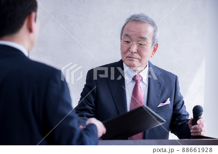 ビジネス　演説の前に部下と打合せをするシニア男性 88661928