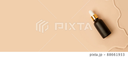 Amber matt glass dropper bottle with white lid in water on beige light background. Skincare products , natural cosmetic. Beauty concept for face and body care 88661933