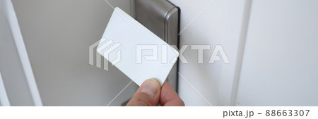 Male hand putting key card to lock on door closeup 88663307