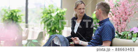 Man and woman in business suits talking and waiting for plane at airport Man and woman in business suits talking and waiting for plane at airport 88663403