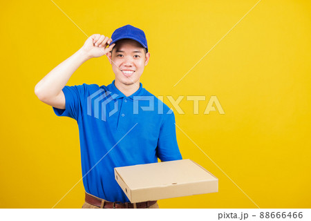 delivery service man standing he smile wearing blue t-shirt and cap uniform hold give food order pizza cardboard boxes delivery service man standing he smile wearing blue t-shirt and cap uniform hold give food order pizza cardboard boxes 88666466