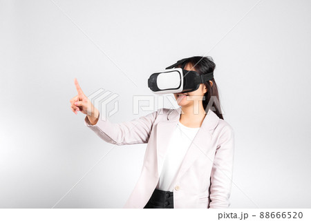Smiling woman confidence wearing VR headset device touching air during virtual reality experience 88666520