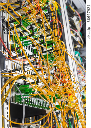 detail of server rack with fiber optic cables attached to front panel switch ports detail of server rack with fiber optic cables attached to front panel switch ports 88667921