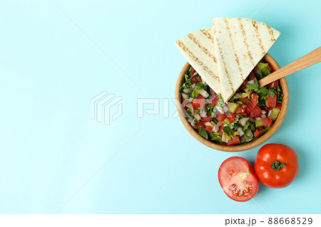 Mexican food concept with Pico de Gallo on blue background Mexican food concept with Pico de Gallo on blue background 88668529