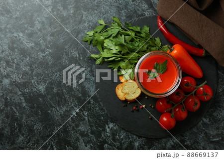 Concept of tasty eating with Gazpacho soup on black smokey background 88669137