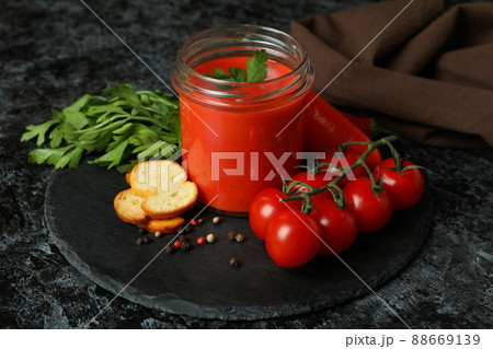 Concept of tasty eating with Gazpacho soup on black smokey background Concept of tasty eating with Gazpacho soup on black smokey background 88669139