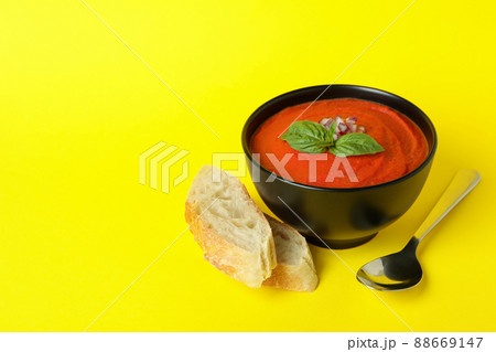 Concept of tasty eating with Gazpacho soup on yellow background 88669147