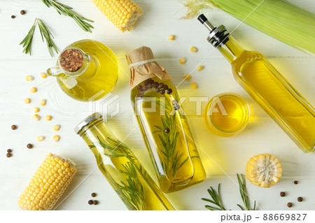 Set of different oils on white wooden table 88669827