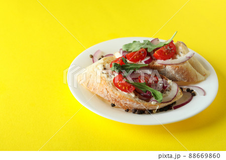 Plate with bruschetta snacks on yellow background Plate with bruschetta snacks on yellow background 88669860