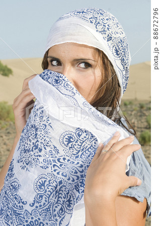 Veiled muslim arabic woman in desert dunes at sunset  88672796