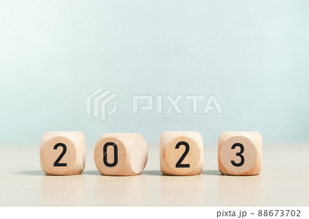 woodblocks cubes square with number 2023 on wood table. business goals next year. woodblocks cubes square with number 2023 on wood table. business goals next year. 88673702