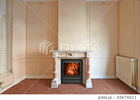 Marble fireplace in empty classical aged apartment 88674821