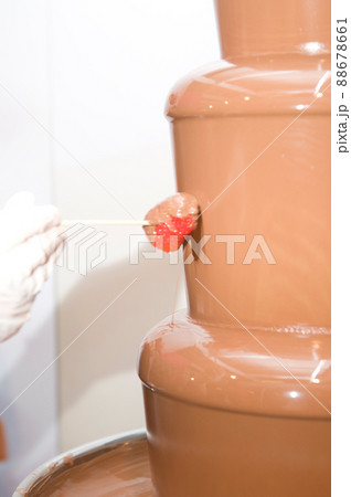 melted chocolate fountain to eat with fruit or treats at a wedding or celebration 88678661