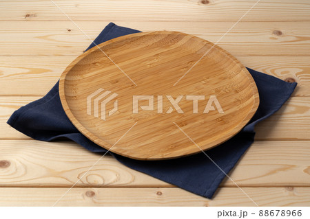 Cutting board with cotton napkin on wooden table Cutting board with cotton napkin on wooden table 88678966
