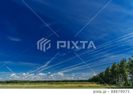 White jet passenger plane flying at high altitude in a blue clear cloudless sky. White jet passenger plane flying at high altitude in a blue clear cloudless sky. 88679075