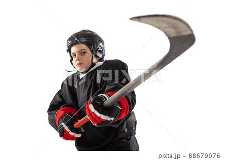Portrait of boy, child, hockey player posing, training isolated over white studio background 88679076
