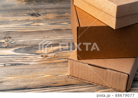 Pile of cardboard boxes on wooden background Pile of cardboard boxes on wooden background 88679077