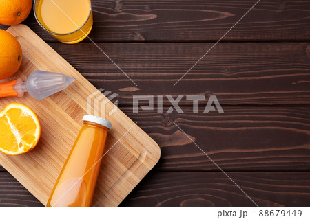 Glass of fresh orange juice with fresh fruits on wooden table 88679449