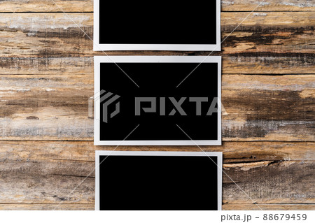 Blank photo frames for your photos on wooden background Blank photo frames for your photos on wooden background 88679459