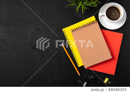 Three notepads on a black table close up Three notepads on a black table close up 88680205