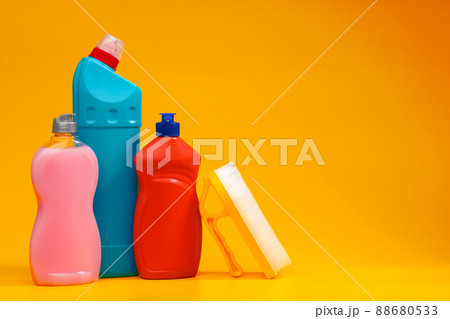 House cleaning detergent bottles on a yellow background House cleaning detergent bottles on a yellow background 88680533